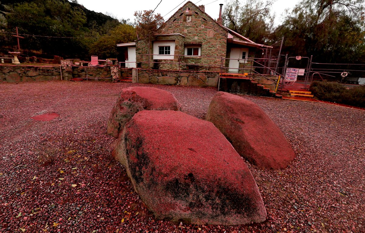 A house is covered with fire retardant.
