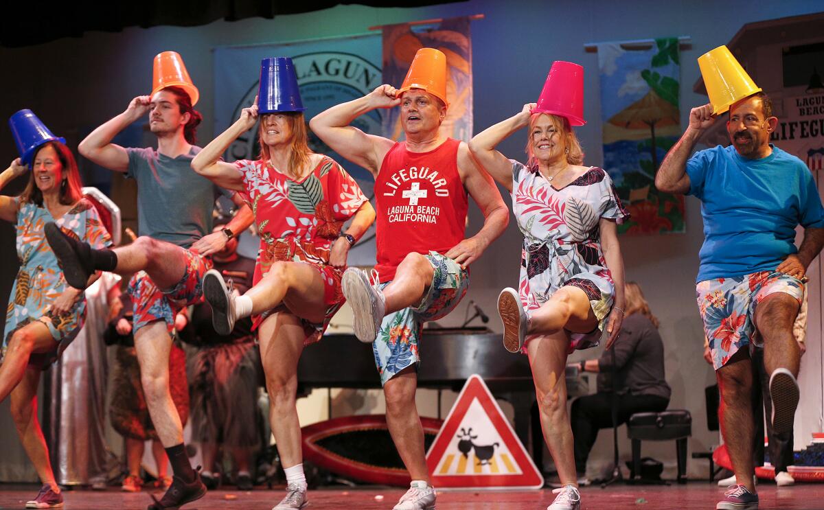 Cast members rehearse a scene from “One-Day Vacation” for the Laguna Beach community parody show Lagunatics. 