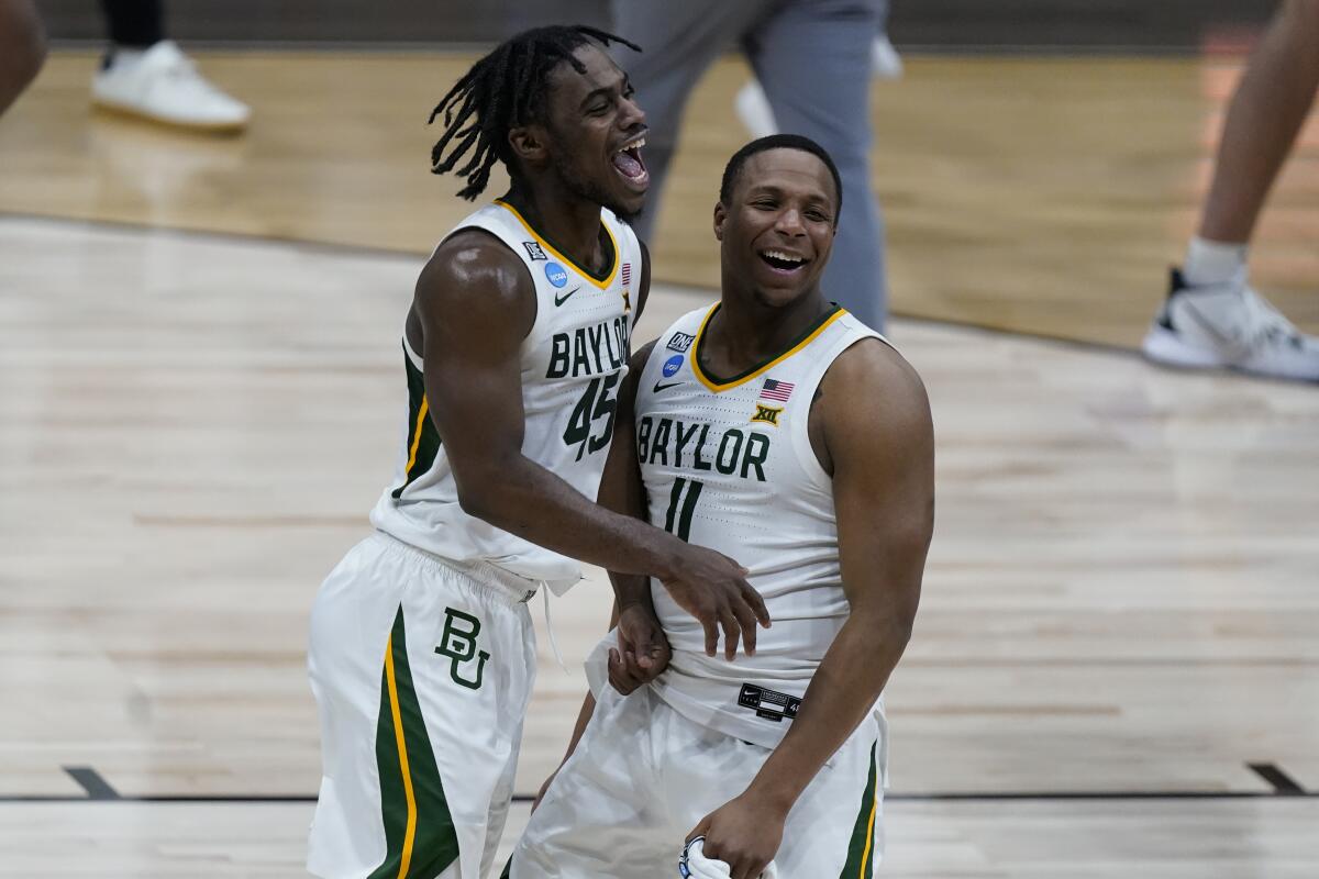 Baylor guard Davion Mitchell and Mark Vital celebrate after beating Arkansas.