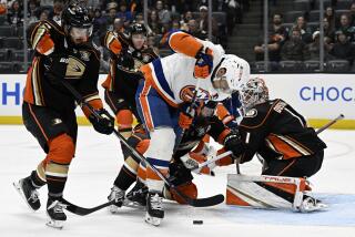 New York Islanders left wing Anders Lee (27) eyes the puck beneath with Anaheim Ducks center.
