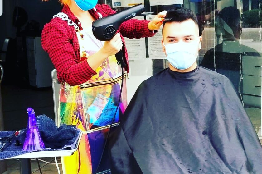 Juliana Fox cutting hair the same day she learned that the salon she works at would be permanently closed because of the COVID-19 pandemic.