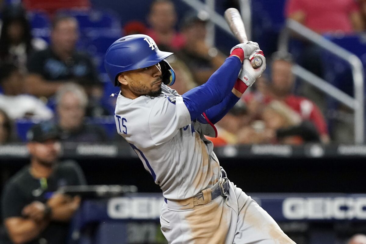 Mookie Betts hits a two-run home run for the Dodgers against the Miami Marlins in August.
