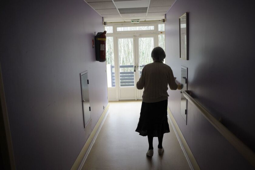 (FILES) In this file photo taken on March 18, 2011 a woman, suffering from Alzheimer's desease, walks in a corridor in a retirement house in Angervilliers, eastern France. Construction has started on May 30, 2018 on the first "Alzheimer village" near Dax, France, the second in Europe, where new forms of medical support will be experimented. / AFP PHOTO / SEBASTIEN BOZONSEBASTIEN BOZON/AFP/Getty Images ** OUTS - ELSENT, FPG, CM - OUTS * NM, PH, VA if sourced by CT, LA or MoD **