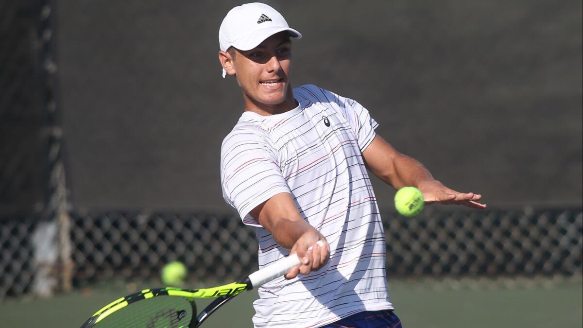 Newport Beach's Austin Di Giulio makes a forehand return in his match against Andre Saleh in the boys' 18 singles round of 16 match in the Southern California Junior Sectionals tennis tournament at the Los Caballeros Sports Village in Fountain Valley on Friday.