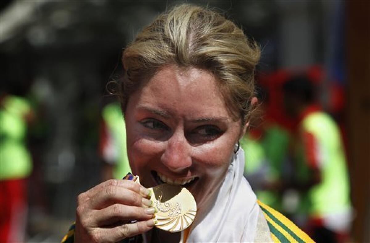 Rochelle Gilmore of Australia displays her gold she won in the women's 112km road race during the Commonwealth Games in New Delhi, India, Sunday, Oct. 10, 2010. (AP Photo/Saurabh Das)