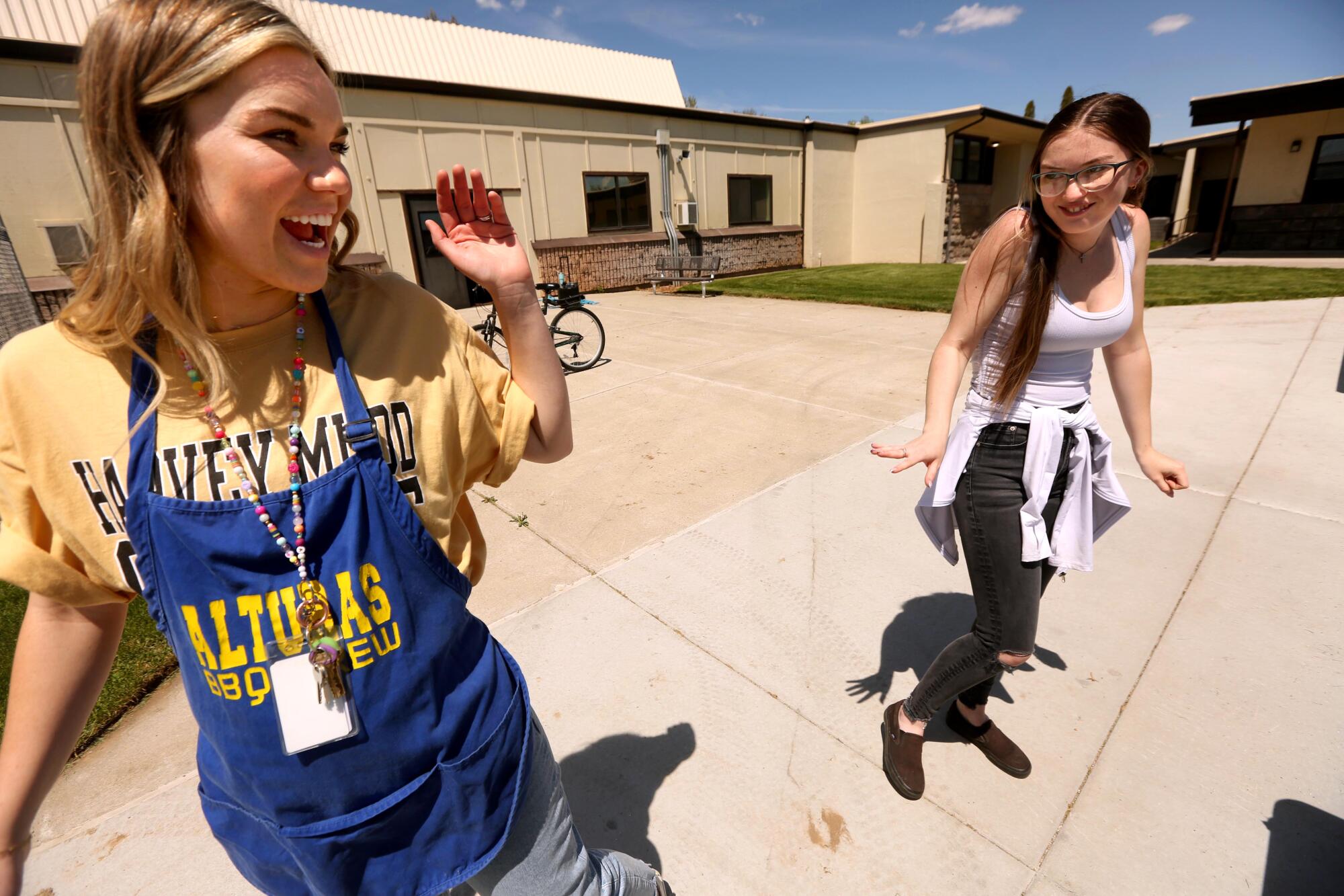 School counselor Candice Boudreaux, left, greets senior Linda Plumlee at Modoc High School in Alturas.