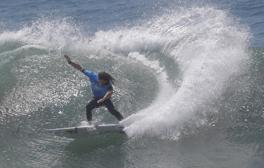 Nolan Rapoza from Long Beach competes in the second round of the Vans U.S. Open of Surfing men's competition.  