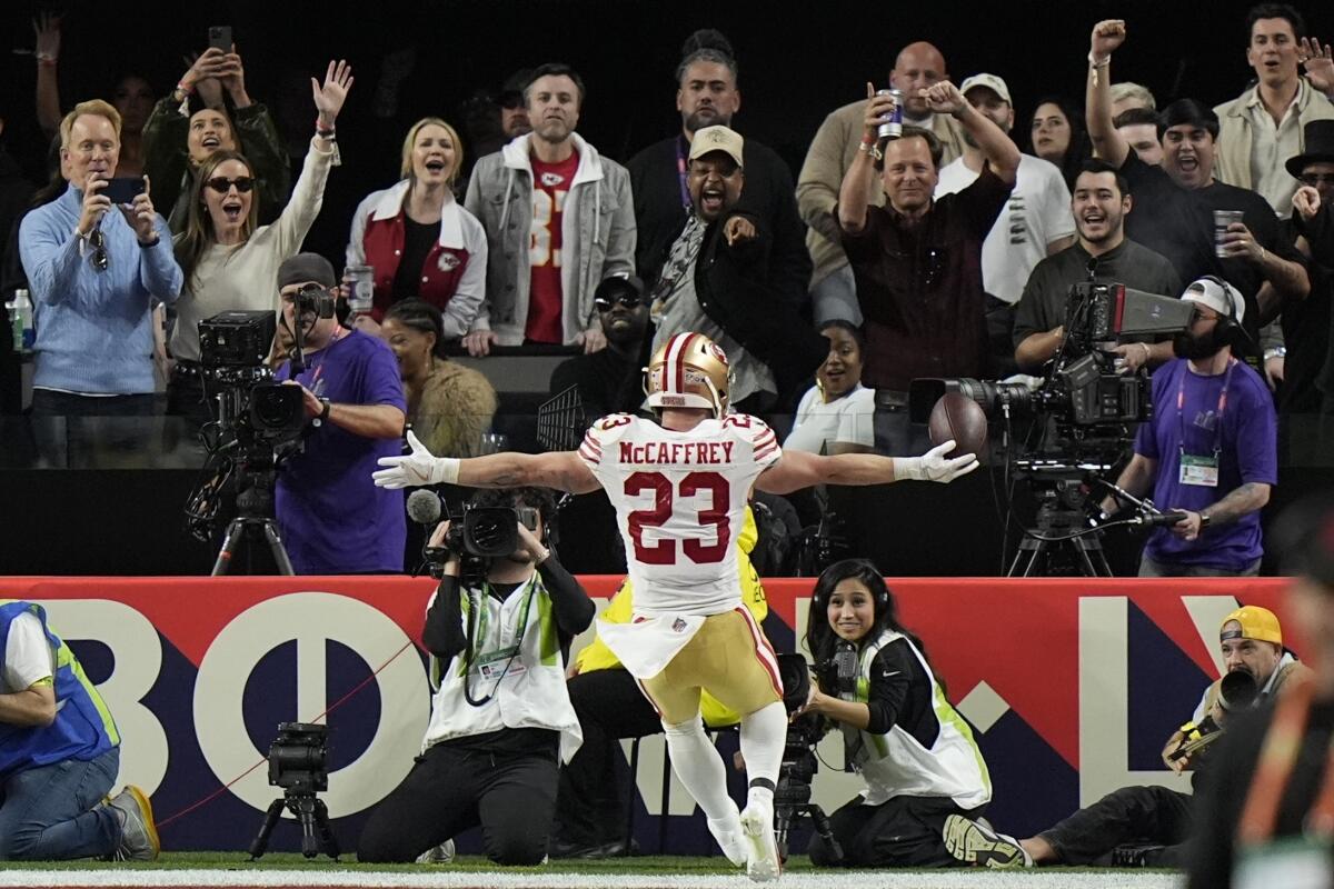 San Francisco 49ers running back Christian McCaffrey celebrates after scoring on a 21-yard touchdown catch.