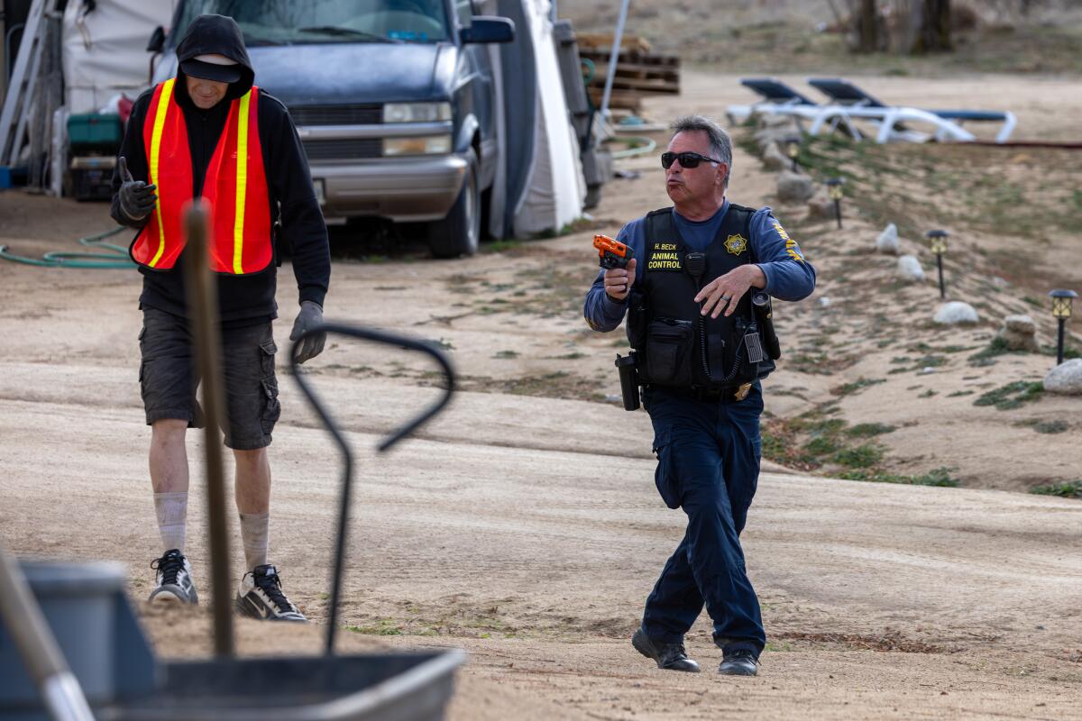 A Riverside County animal control officer orders an uncooperative man to stay in his trailer in Aguanga.