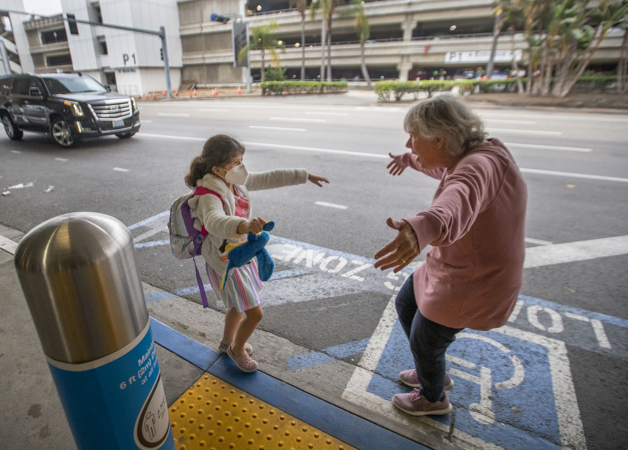 Jacquie Carney, 7, of San Antonio runs to hug her grandmother, Donna Vidrine of San Clemente at LAX.