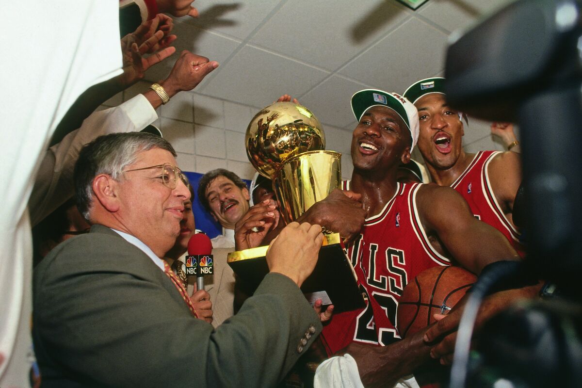 NBA Commissioner David Stern presents Michael Jordan and the Chicago Bulls the championship trophy after the Bulls defeated the Phoenix Suns in the 1993 NBA Finals.