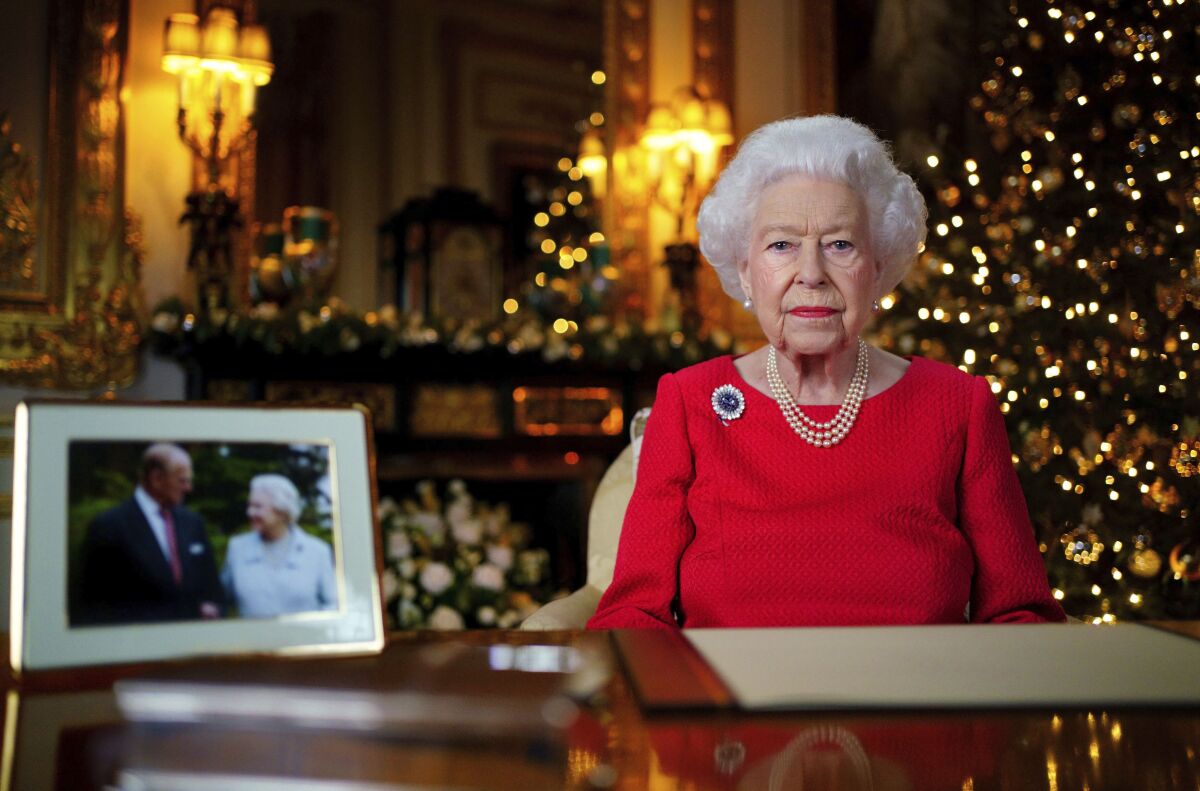 Queen Elizabeth II with Christmas decorations behind her
