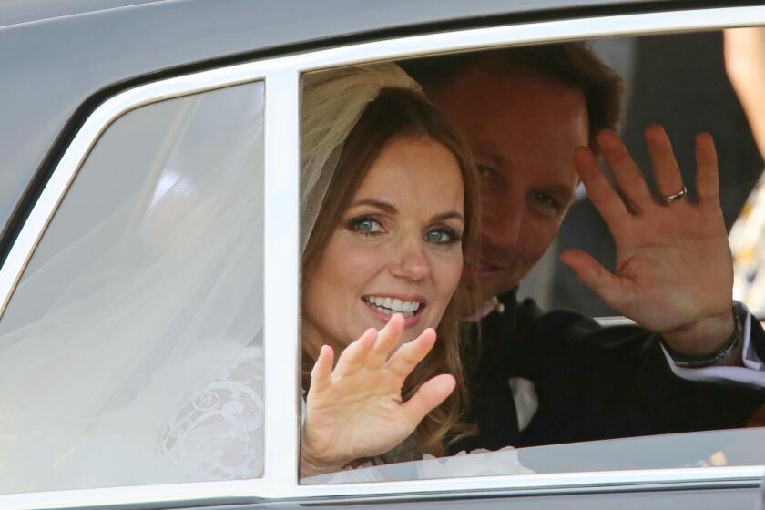 Spice Girl Geri Halliwell and Formula One boss Christian Horner wave after their wedding in Woburn, England.