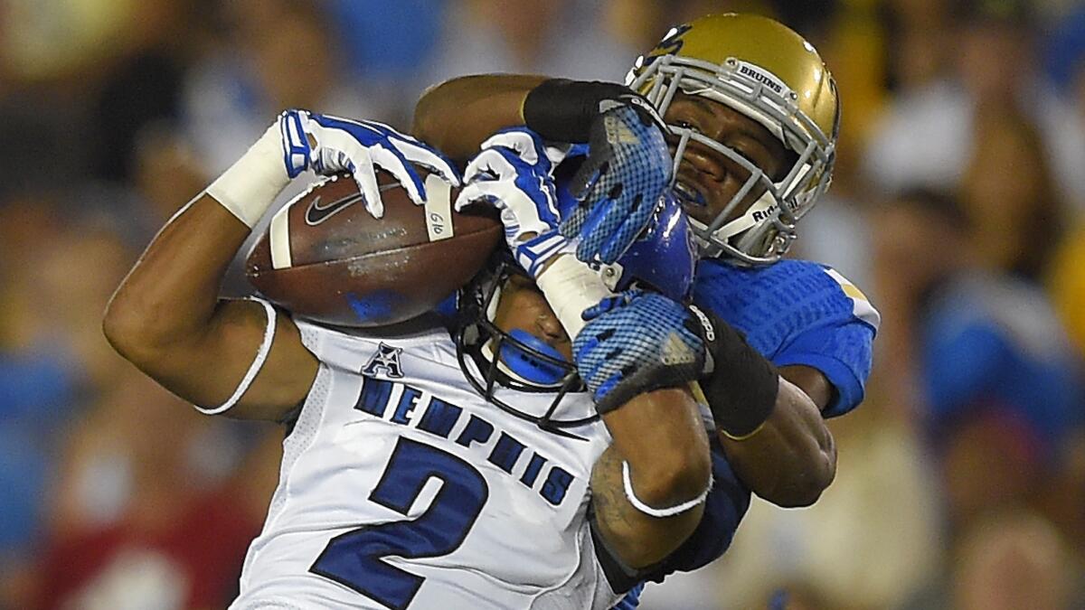 Memphis wide receiver Joe Craig makes a catch in front of UCLA cornerback Fabian Moreau during the Bruins' win Sept. 6.