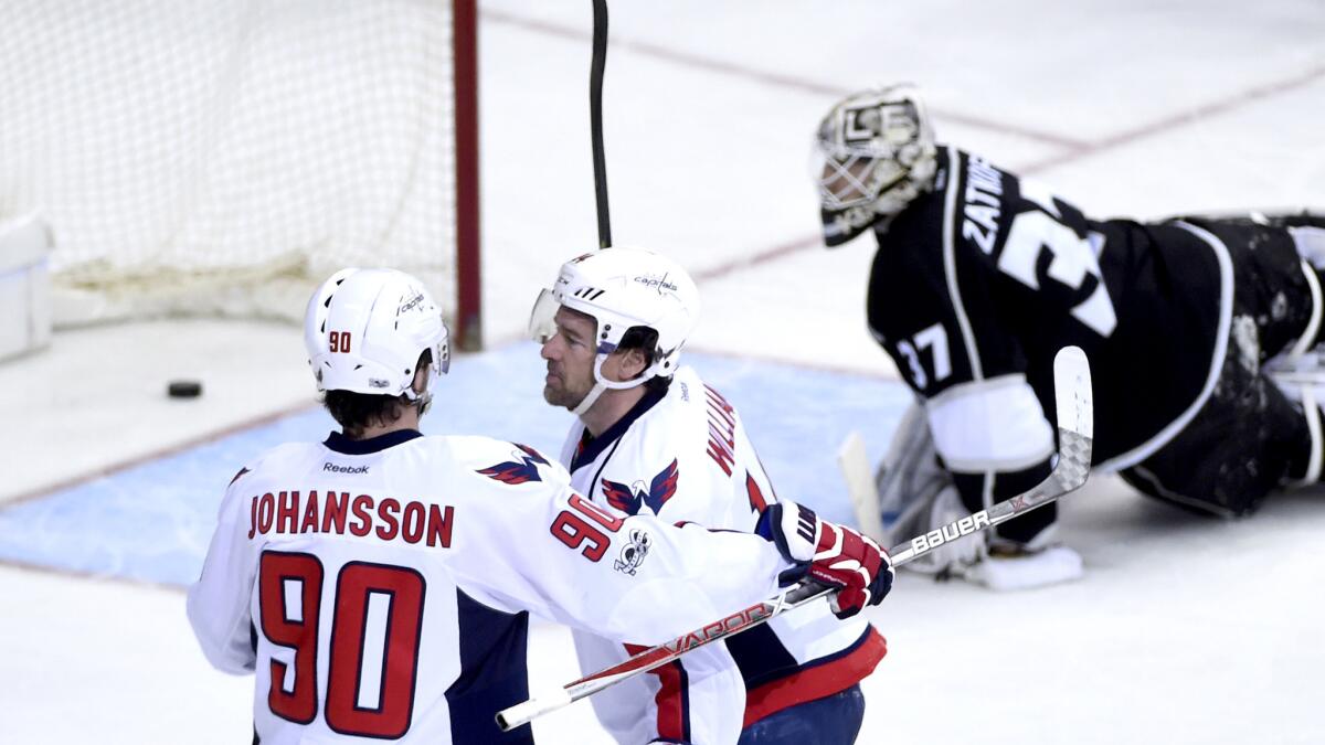 Capitals right wing Justin Williams (14) celebrates with teammate Marcus Johansson after scoring against Kings goalie Jeff Zatkoff (37) during the third period Sunday.