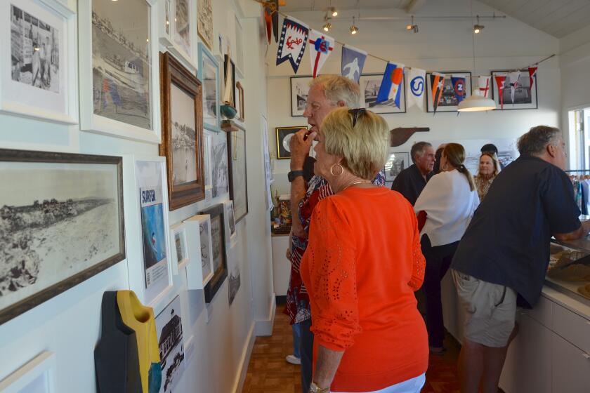 John Vallely studies a historical photo with his wife, Karen.