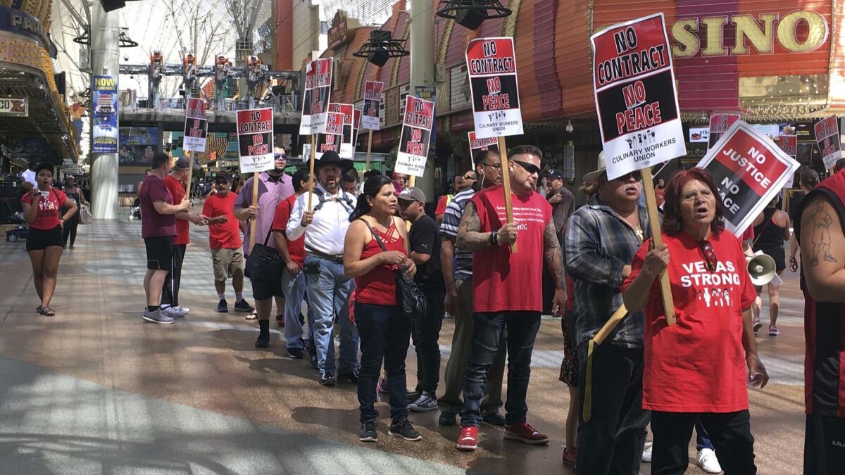 Housekeepers, bartenders and other unionized workers picket Friday outside a Las Vegas casino-hotel in their latest push for a new contract.