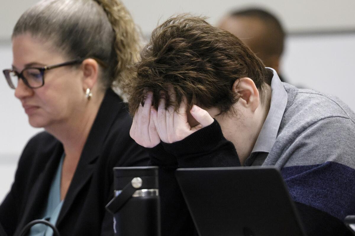 Marjory Stoneman Douglas High School shooter Nikolas Cruz rubs his eyes during the penalty phase of Cruz's trial at the Broward County Courthouse in Fort Lauderdale on Tuesday, Oct. 4, 2022. Cruz previously plead guilty to all 17 counts of premeditated murder and 17 counts of attempted murder in the 2018 shootings. (Amy Beth Bennett/South Florida Sun Sentinel via AP, Pool)