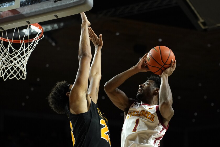 Iowa State guard Izaiah Brockington (1) drives to the basket over Arkansas-Pine Bluff forward Trey Sampson, left, during the first half of an NCAA college basketball game, Wednesday, Dec. 1, 2021, in Ames, Iowa. (AP Photo/Charlie Neibergall)