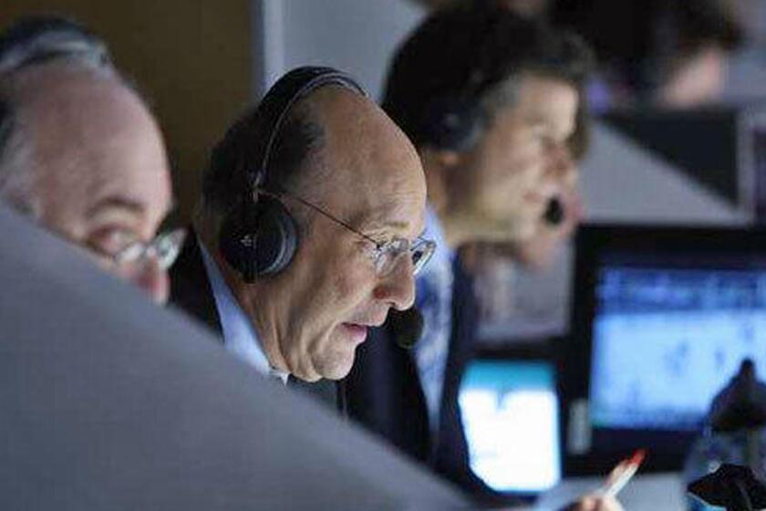 Kings play-by-play announcer Bob Miller, center, calls a game against the Edmonton Oilers at Staples Center on April 10, 2010.