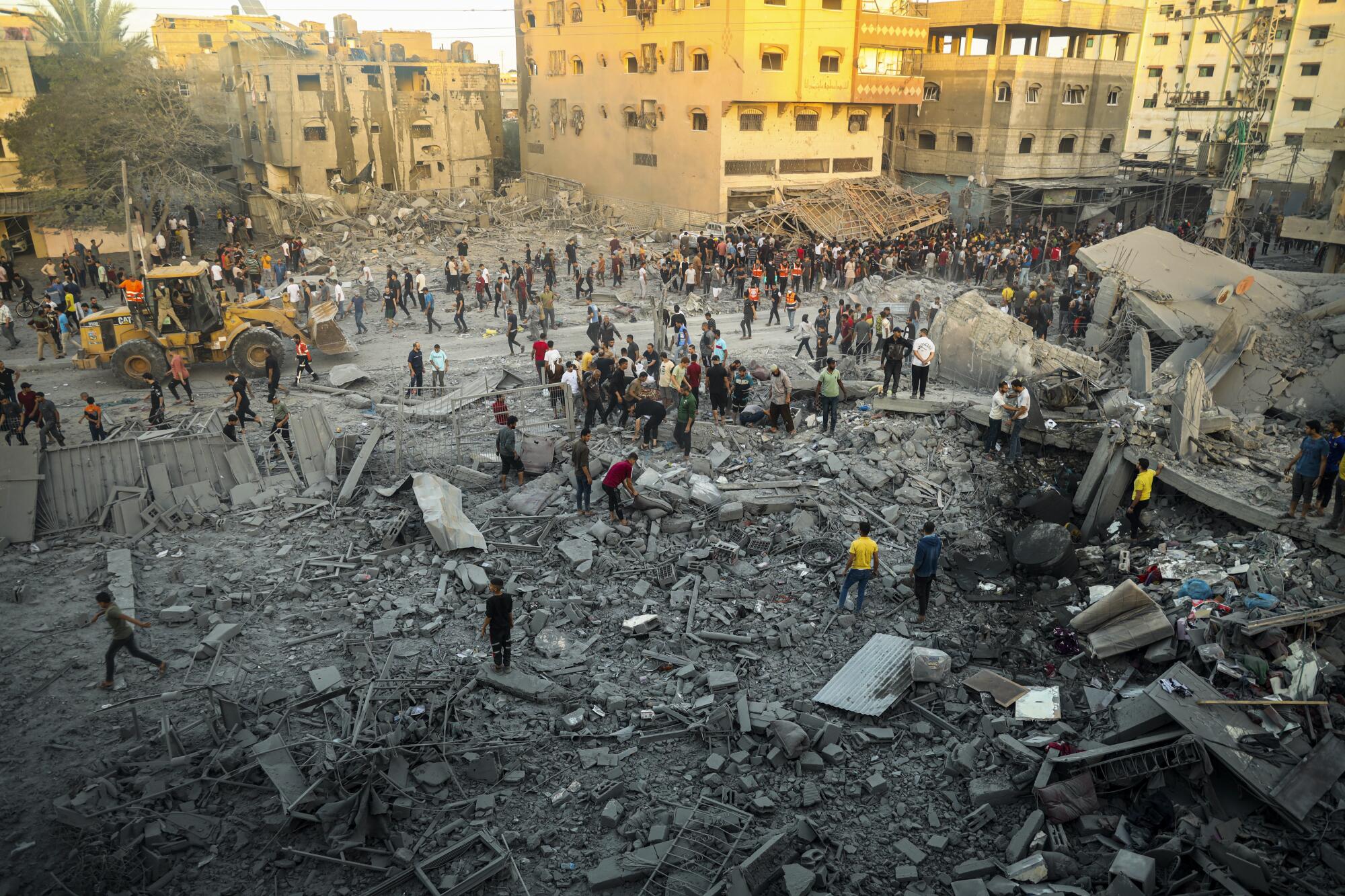 People surveying damage from Israeli airstrike on Rafah in the Gaza Strip