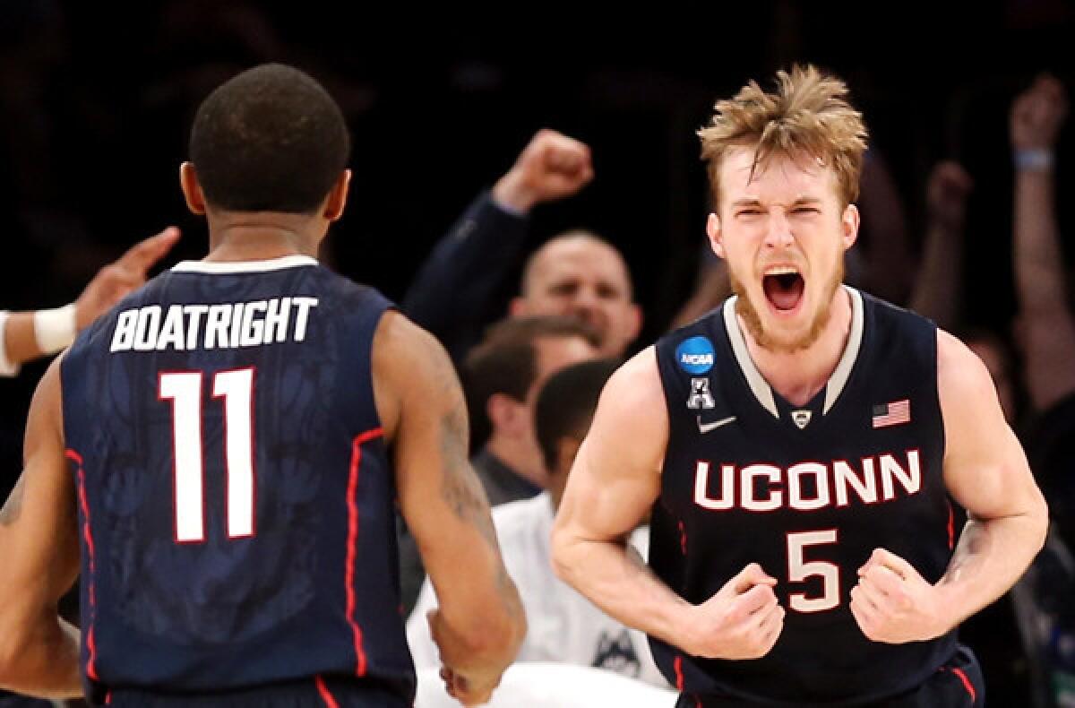 Connecticut forward Niels Giffey (5) reacts along with teammate Ryan Boatright after making a shot against Iowa State during an NCAA tournament East Regional semifinal on Friday night in New York.