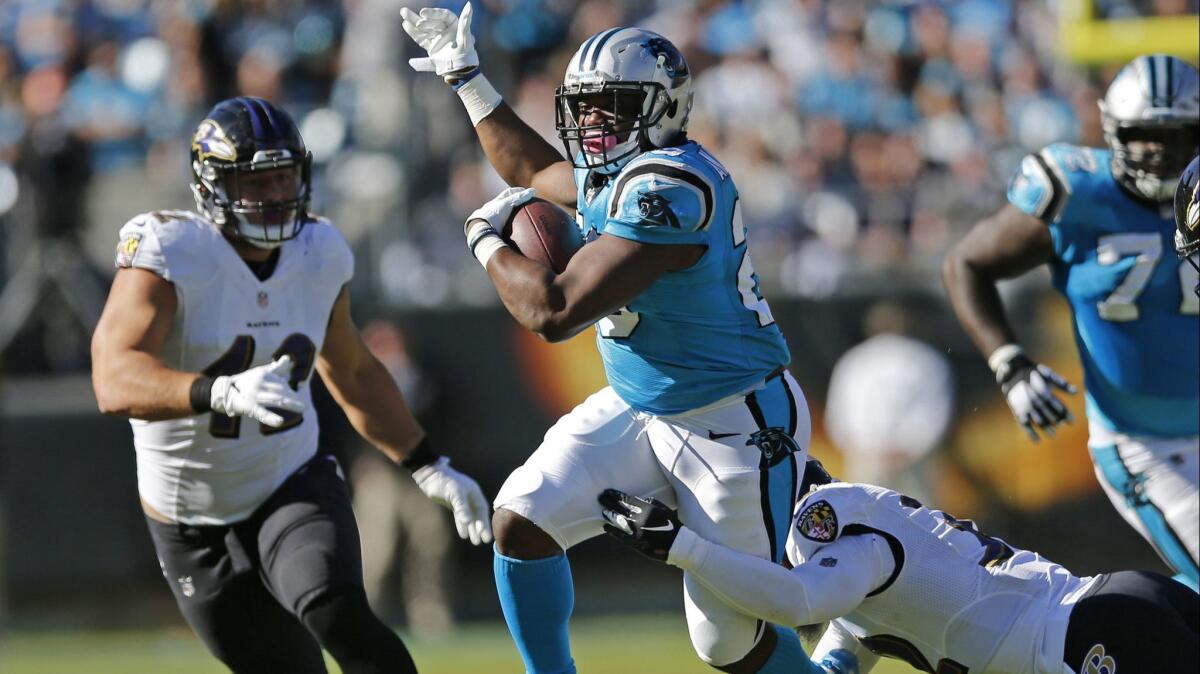 Carolina Panthers running back C.J. Anderson (20) runs as Baltimore Ravens' Patrick Ricard (42) defends in a game Oct. 28. The Panthers waived Anderson, who was a 1,000-yard rusher in 2017 for the Denver Broncos. He was signed by the Rams on Tuesday.