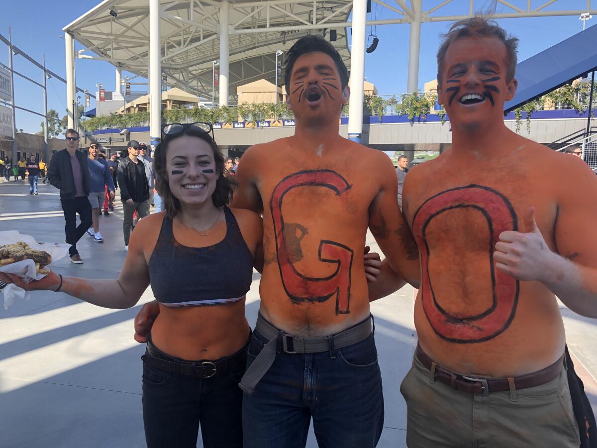 Sierra Scolaro, left, Austin Henry and Garett Turner show their support for the Wildcats, L.A.'s XFL team.