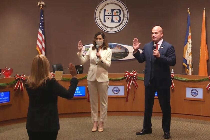 Huntington Beach City Clerk Robin Estanislau swore in new mayor Kim Carr and mayor pro tem Tito Ortiz