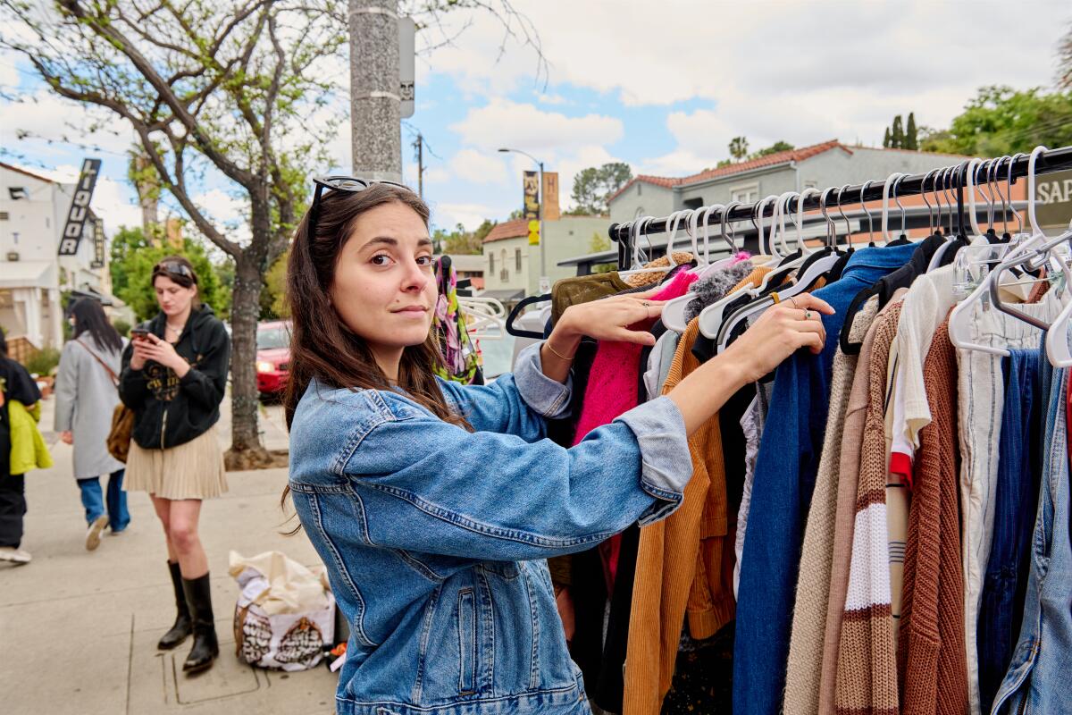 Bottom row from left: Kristen Vaganos goes through her clothing rack.