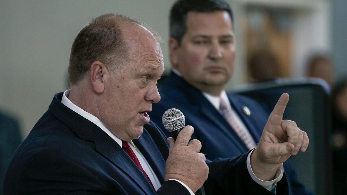 Hundreds of Sacramento residents protested, listened and shouted while acting ICE Director Thomas Homan, left, and Sacramento County Sheriff Scott Jones held a community forum. (Mark Boster / Los Angeles Times)