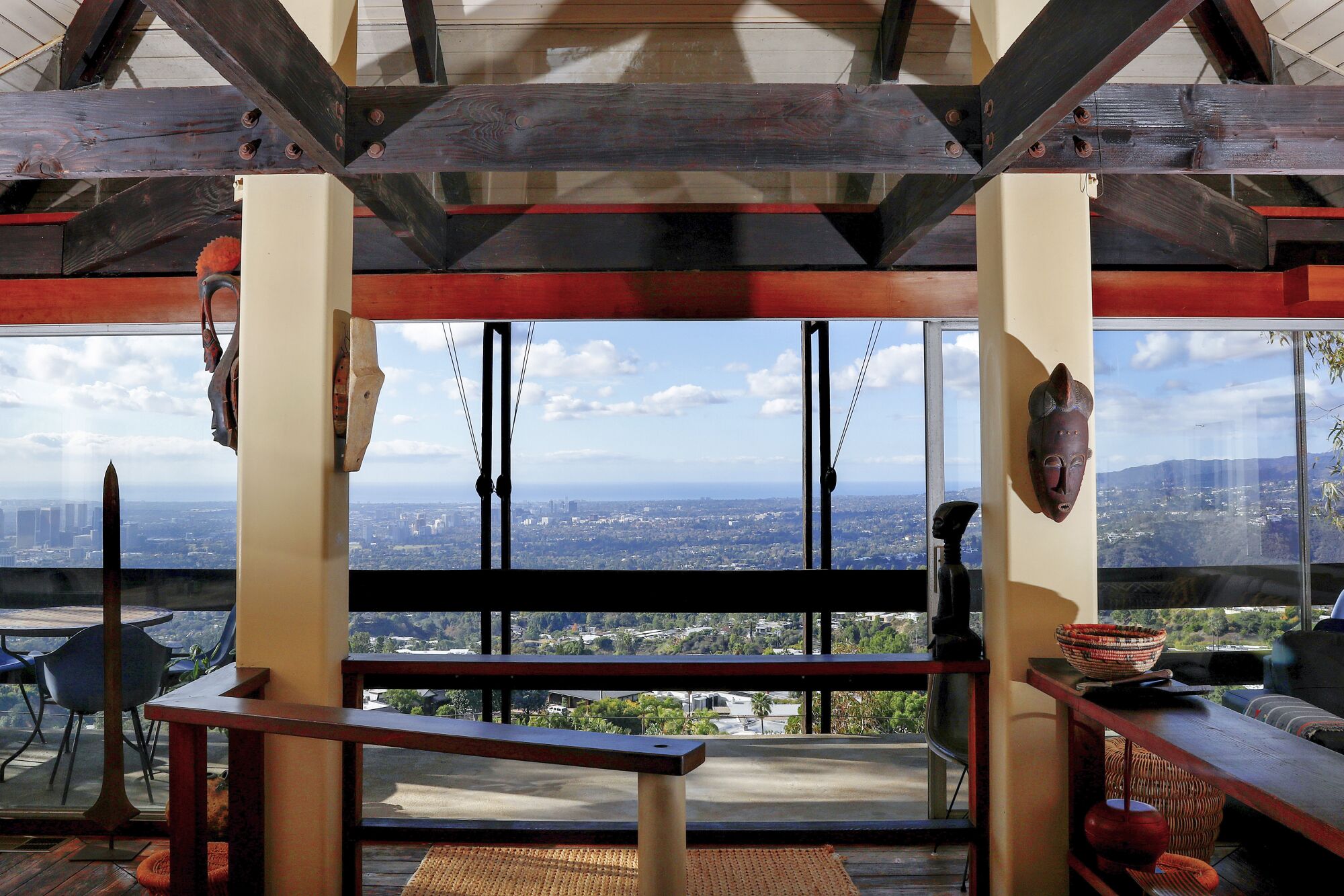 A view of Bernard Judge's Tree House shows a woody living room area with views of the Los Angeles Basin