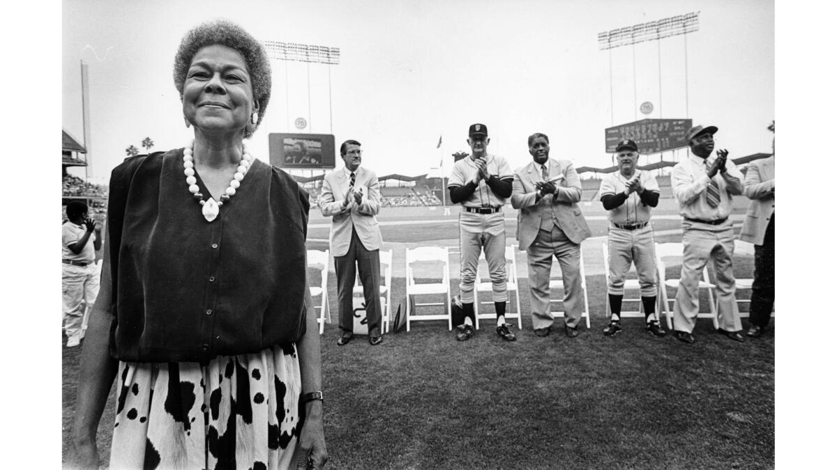 April 11, 1987: Jackie Robinson's wife, Rachel, receives a standing ovation from the fans at Dodger Stadium during ceremonies honoring the 40th anniversary of Robinson’s breaking the major league color barrier.