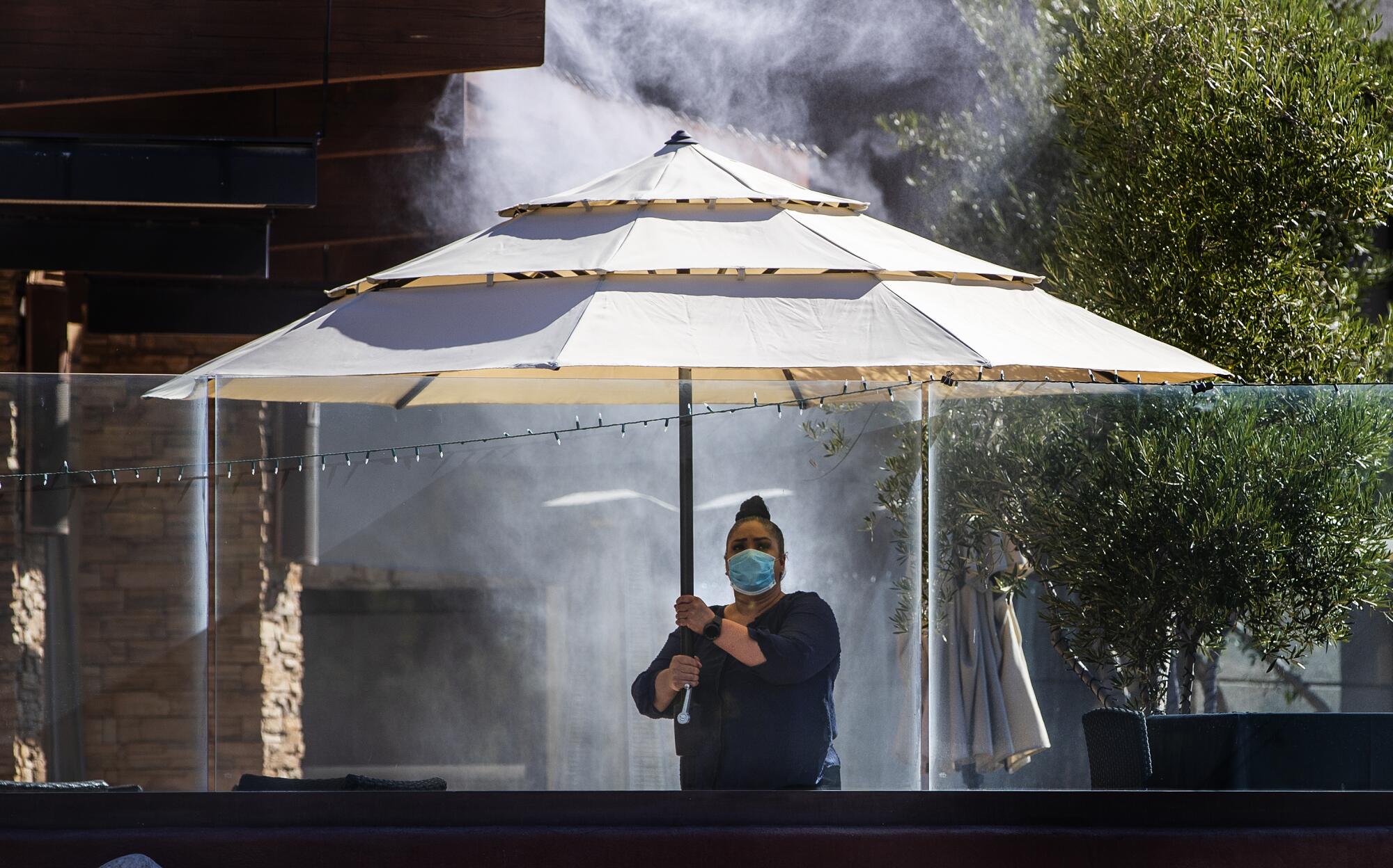 Setting up an umbrella for steakhouse dining in Rancho Mirage