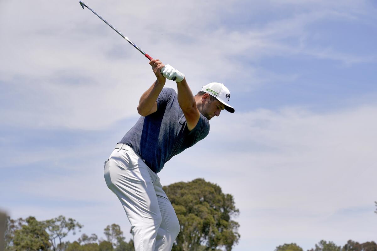 Jon Rahm plays his shot from the eighth tee during a practice round of the U.S. Open.