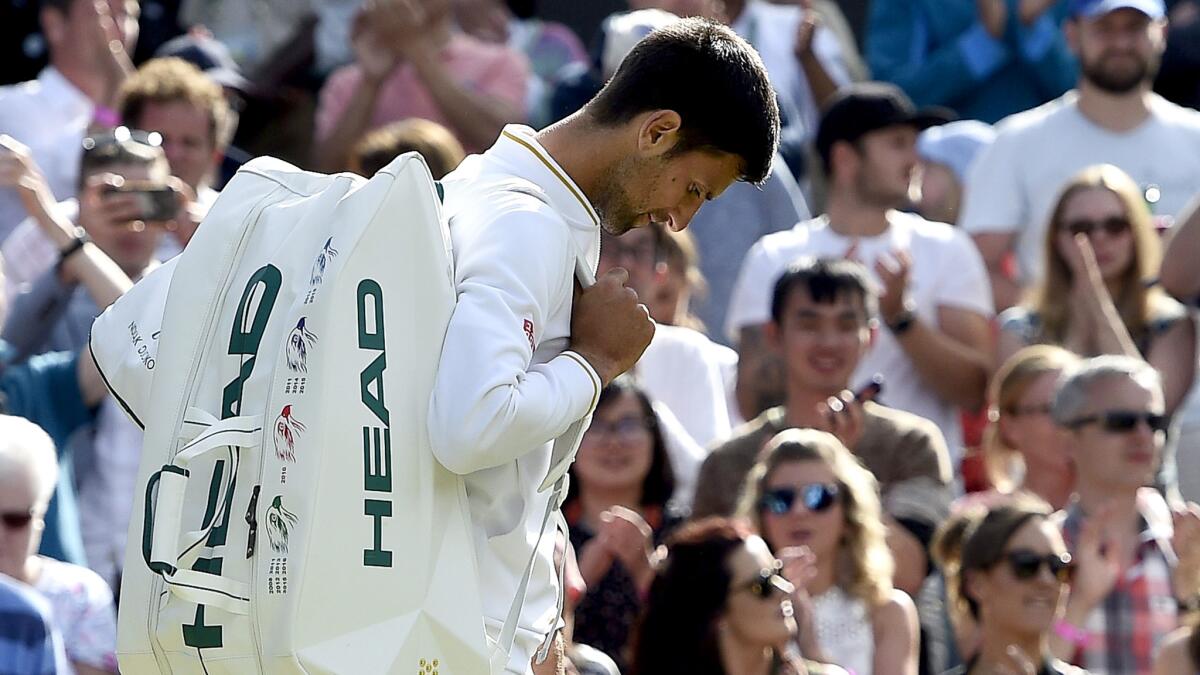 Novak Djokovic walks off the court following his loss to Sam Querrey on Saturday at Wimbledon.