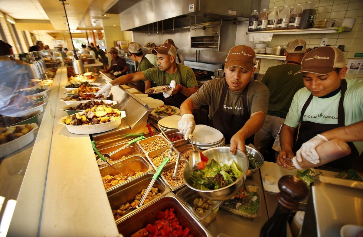 Food preparation workers and restaurant servers are among the low-wage employees studied by UC Berkeley researchers. Above, salad makers prepare lunch at Tender Greens in Santa Monica last year.
