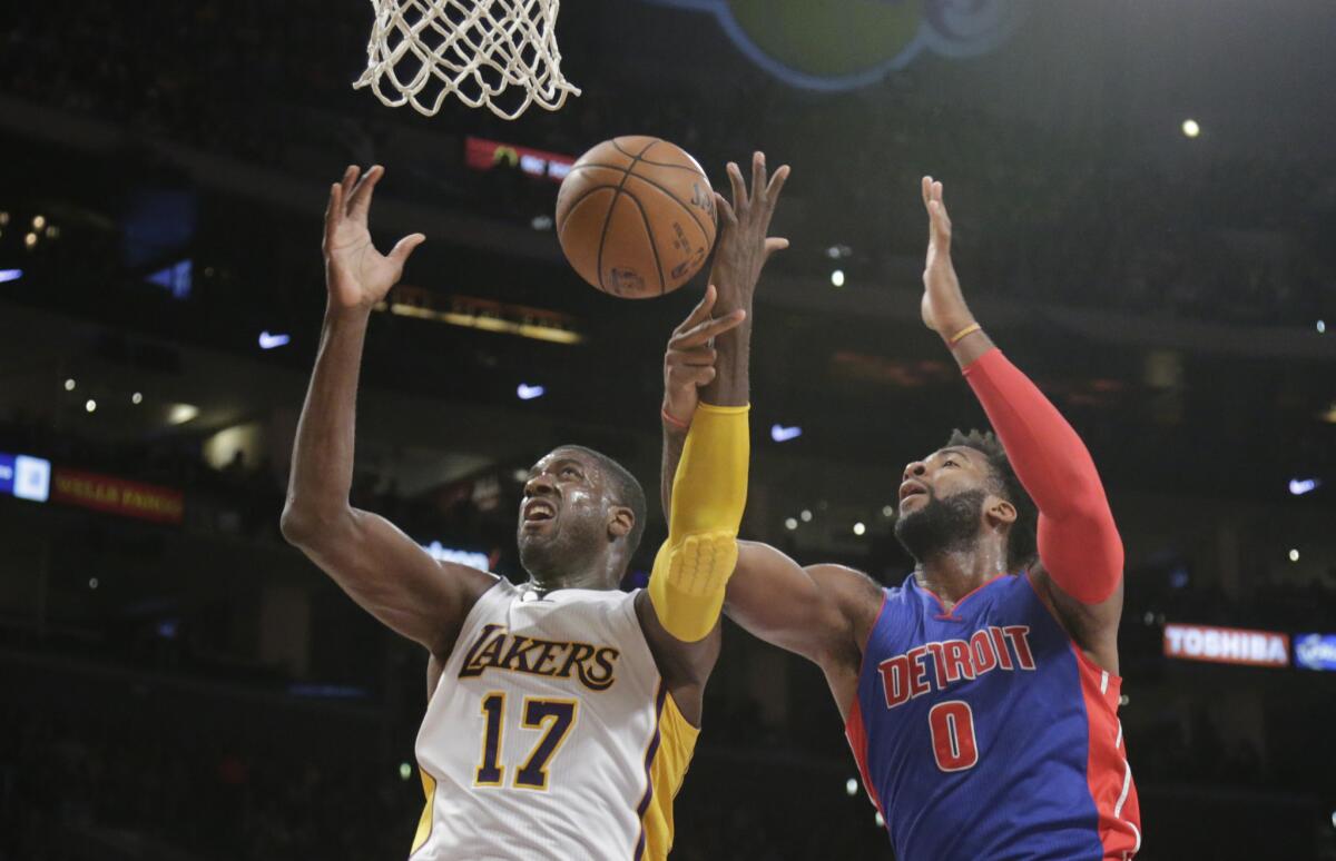 Lakers center Roy Hibbert and Pistons center Andre Drummond battle for a rebound in the first half.