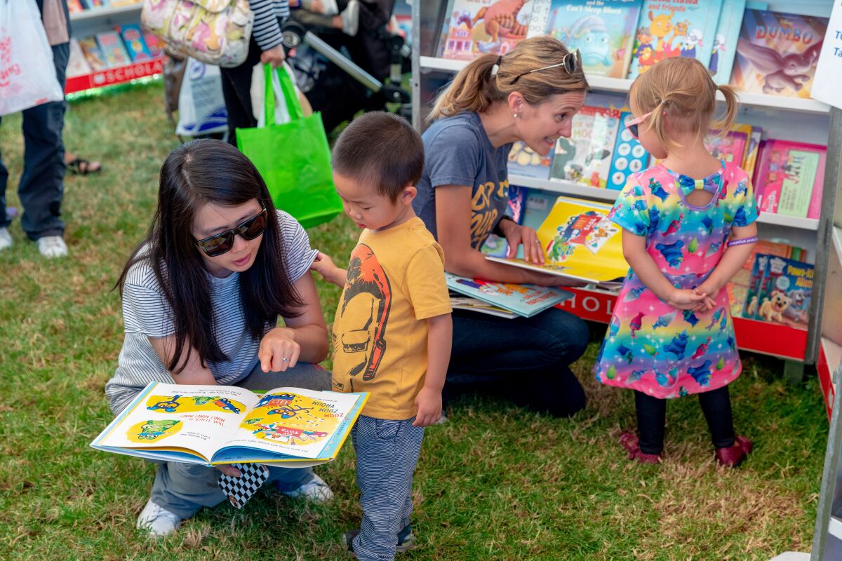 Young readers share an impromptu story time at the Orange County Children's Book Festival, which comes to Costa Mesa Sunday.