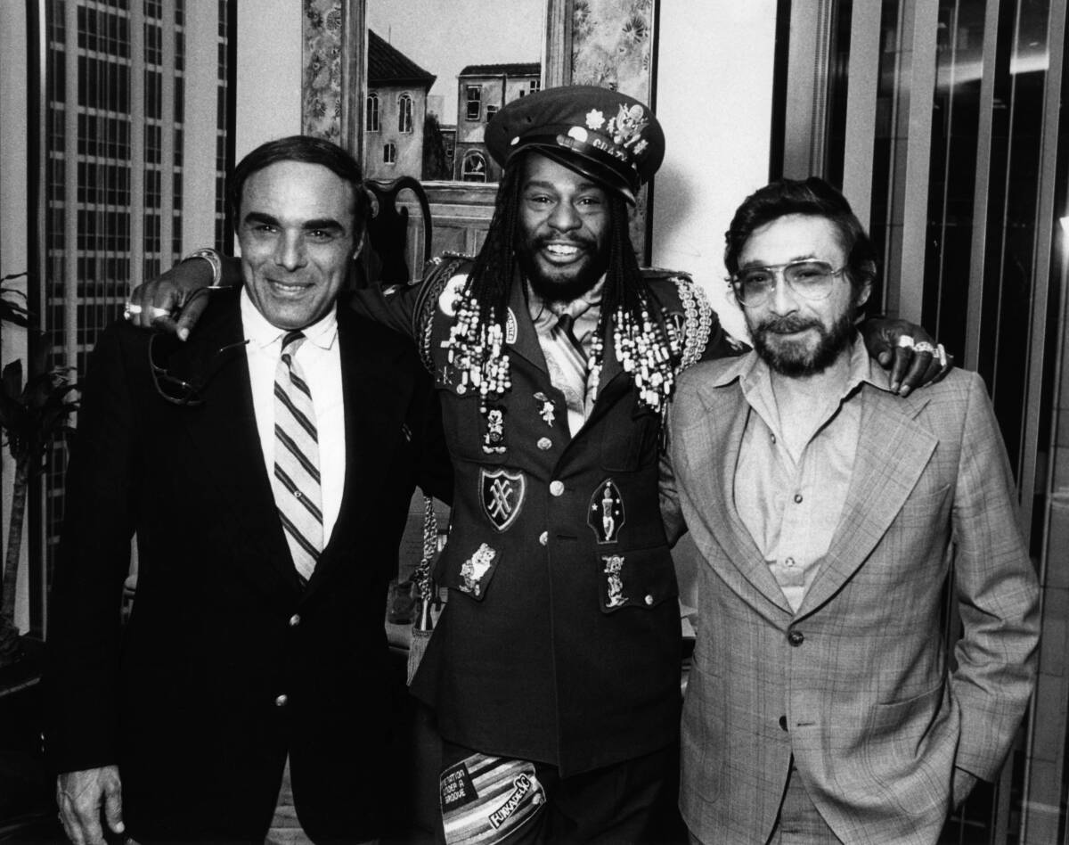 Walter Yetnikoff and another CBS Records executive stand with George Clinton.