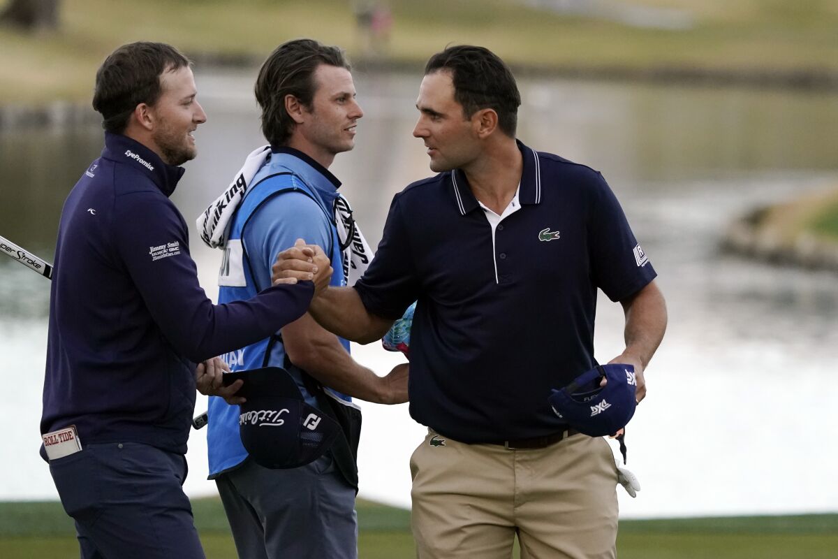 Lee Hodges, left, shakes hands with Paul Barjon after they finished the third round of the American Express on Jan. 22, 2022.