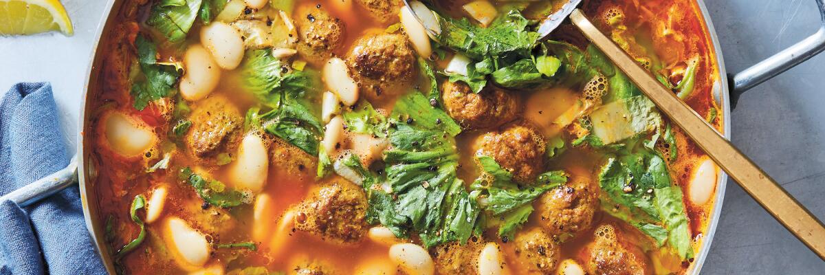 Spiced lamb meatball and escarole soup ready to be ladled from the pot