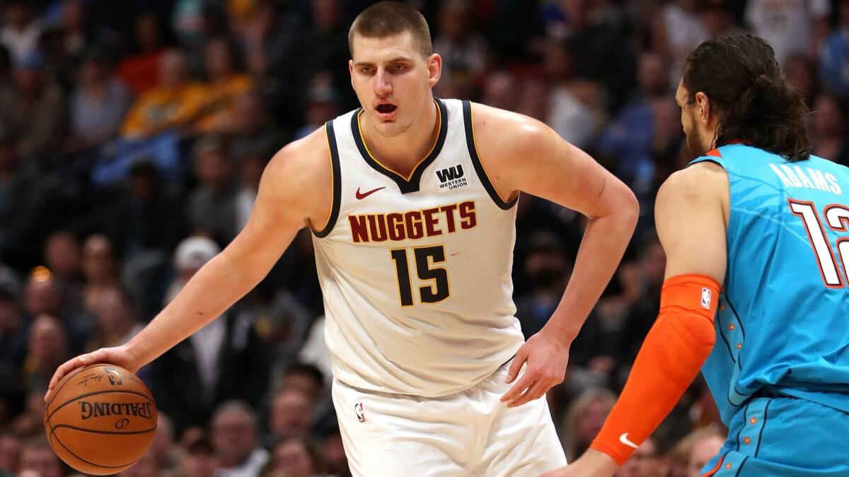 Dever Nuggets center Nikola Jokic drives to the basket against Oklahoma City Thunder center Steven Adams during a game Friday in Denver,