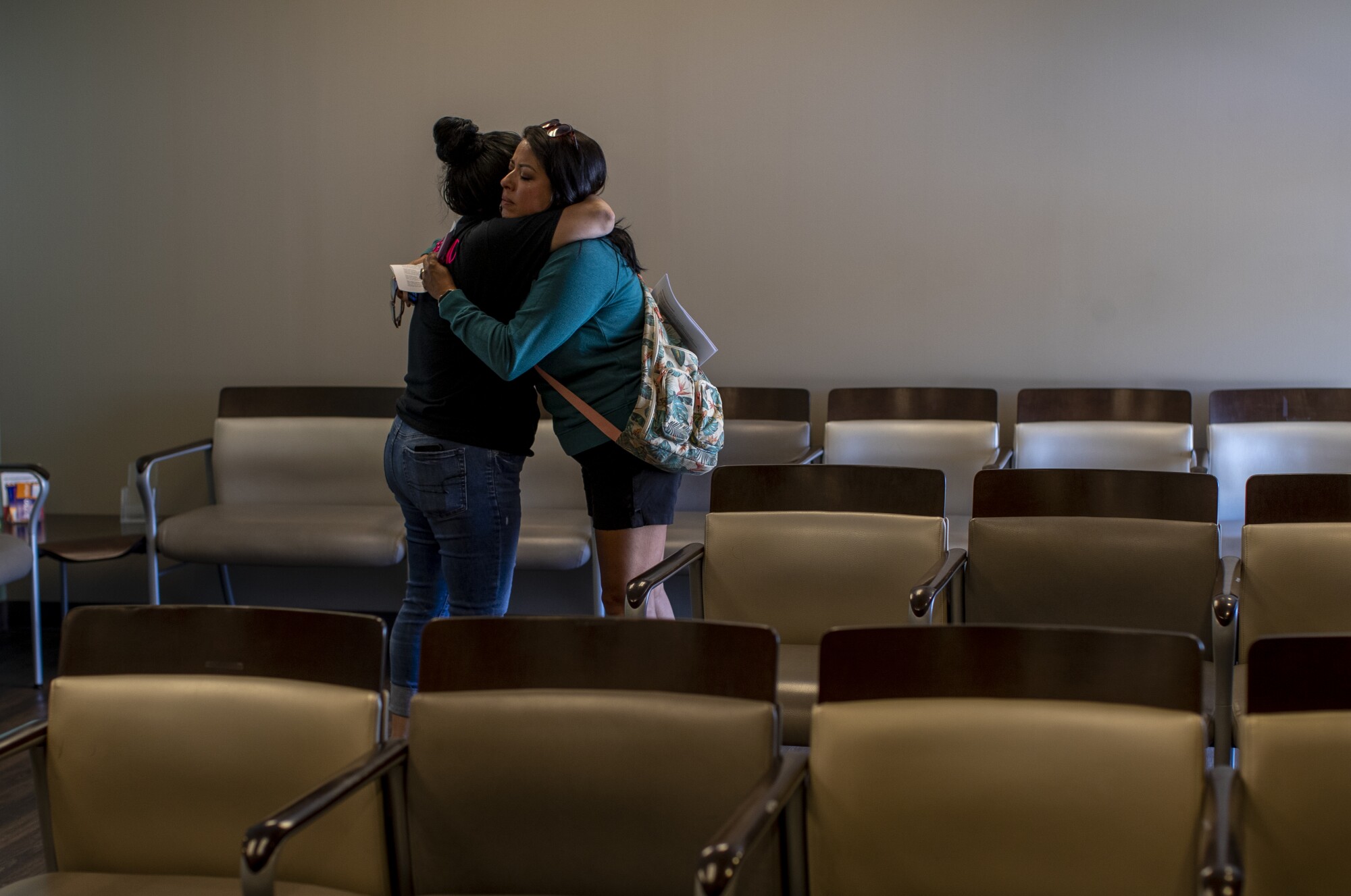 A tearful staff member hugs a patient after informing that the clinic can no longer provide abortion services 