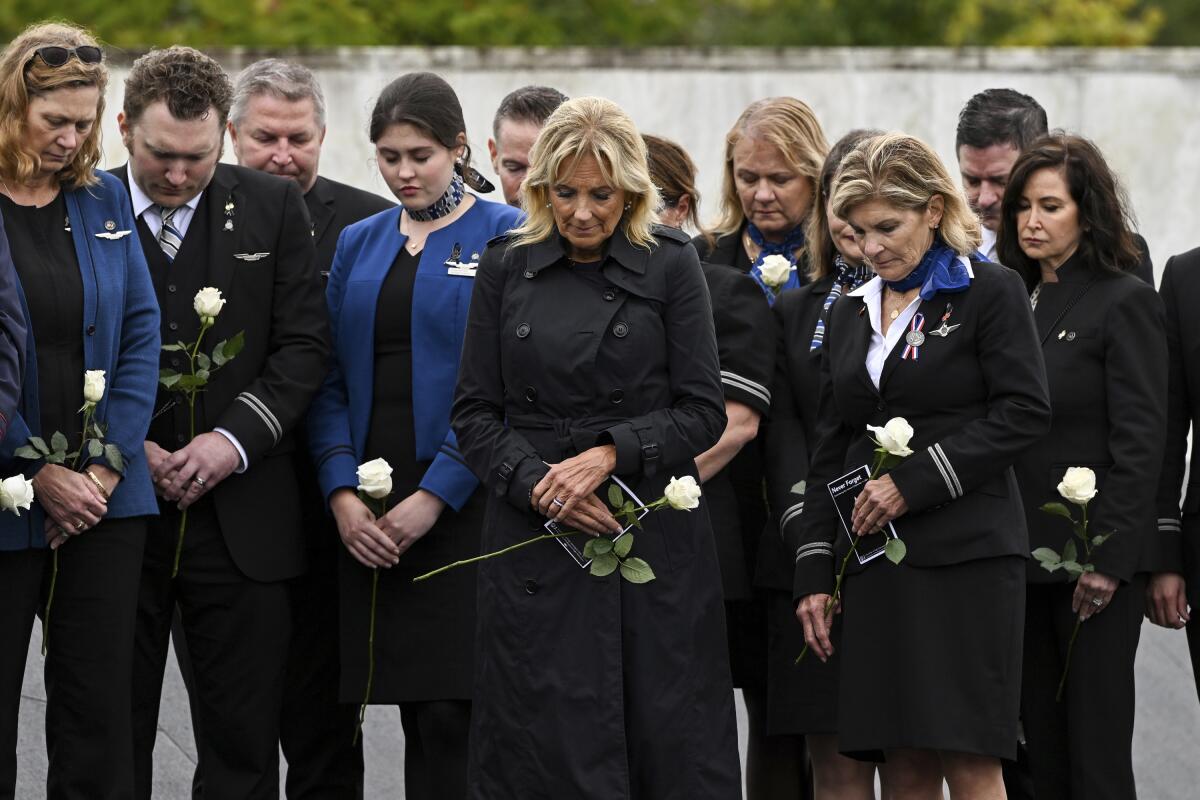 First lady Jill Biden participates in a moment of silence with the members of the Association of Flight Attendants at the Flight 93 National Memorial Wall of Names following a ceremony commemorating the 21st anniversary of the Sept. 11, 2001 terrorist attacks in Shanksville, Pa., Sunday, Sept. 11, 2022. (AP Photo/Barry Reeger)
