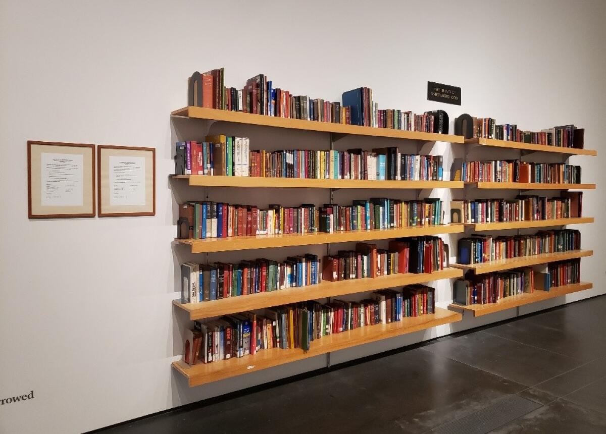Bookshelves hold Meric Algun's commissioned installation: 1,000 books not previously borrowed from the L.A. Public Library.