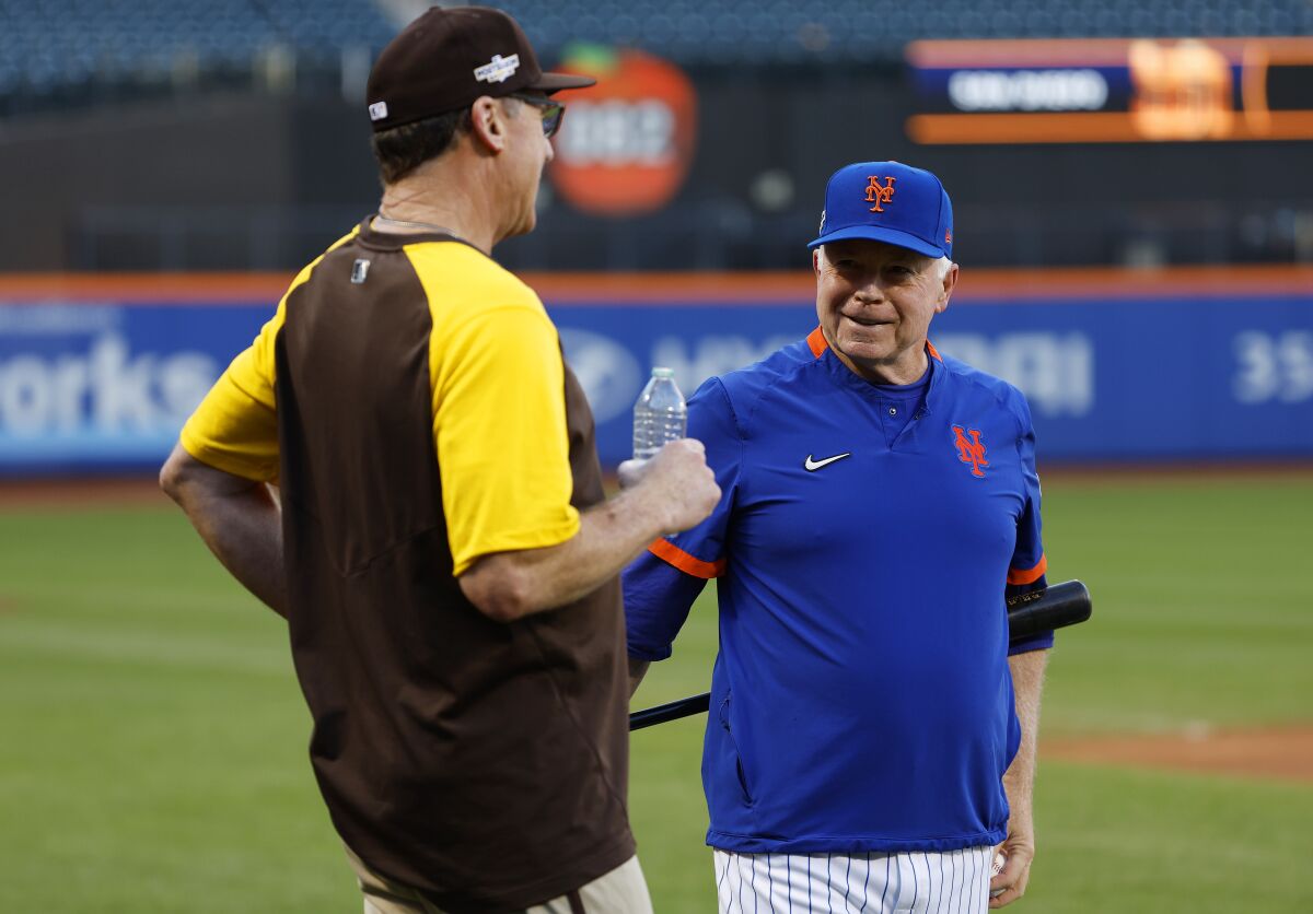 Padres manager Bob Melvin, left, talks with Mets manager Buck Showalter as the teams prepare for Friday's wild-card series.