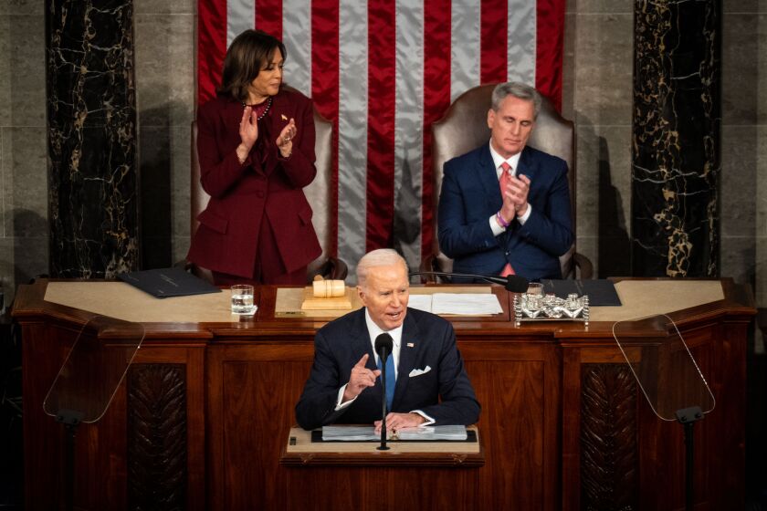WASHINGTON, DC - FEBRUARY 07: President Joe Biden speaks as Vice President Kamala Harris, left, looks over at Speaker of the House Kevin McCarthy (R-CA), right, who remains seated as the President delivers a State of the Union address at the U.S. Capitol on Tuesday, Feb. 7, 2023 in Washington, DC. (Kent Nishimura / Los Angeles Times)