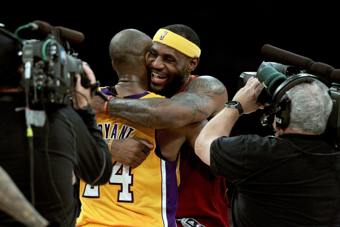 Lakers guard Kobe Bryant embraces Cavaliers forward LeBron James after their game Thursday night at Staples Center.