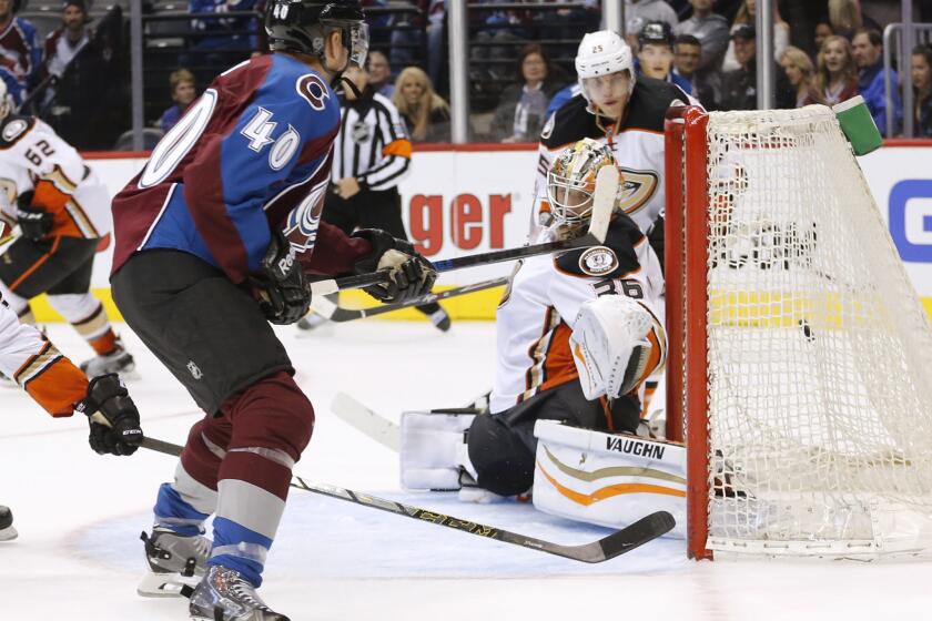 Avalanche forward Alex Tanguay slips the puck past Ducks goalie John Gibson for the game-winner during the overtime period of an preseason game Tuesday.